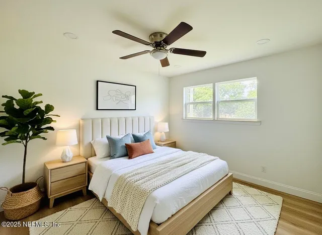 a bedroom with a bed and a potted plant