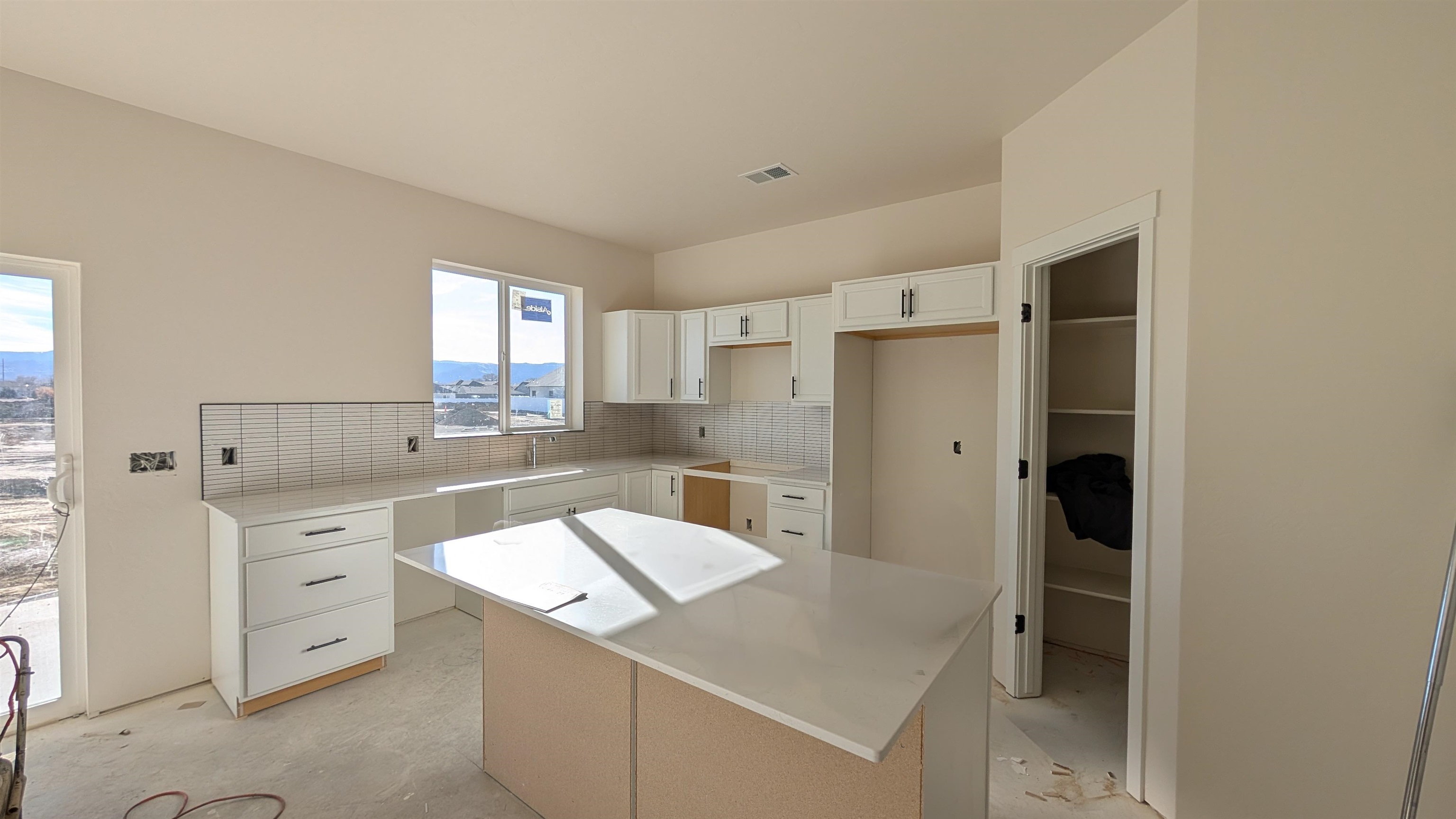 2461 Revere Road, Unit A Grand Junction, CO 81505 - Photo 4 of 15 a kitchen with a refrigerator sink and cabinets