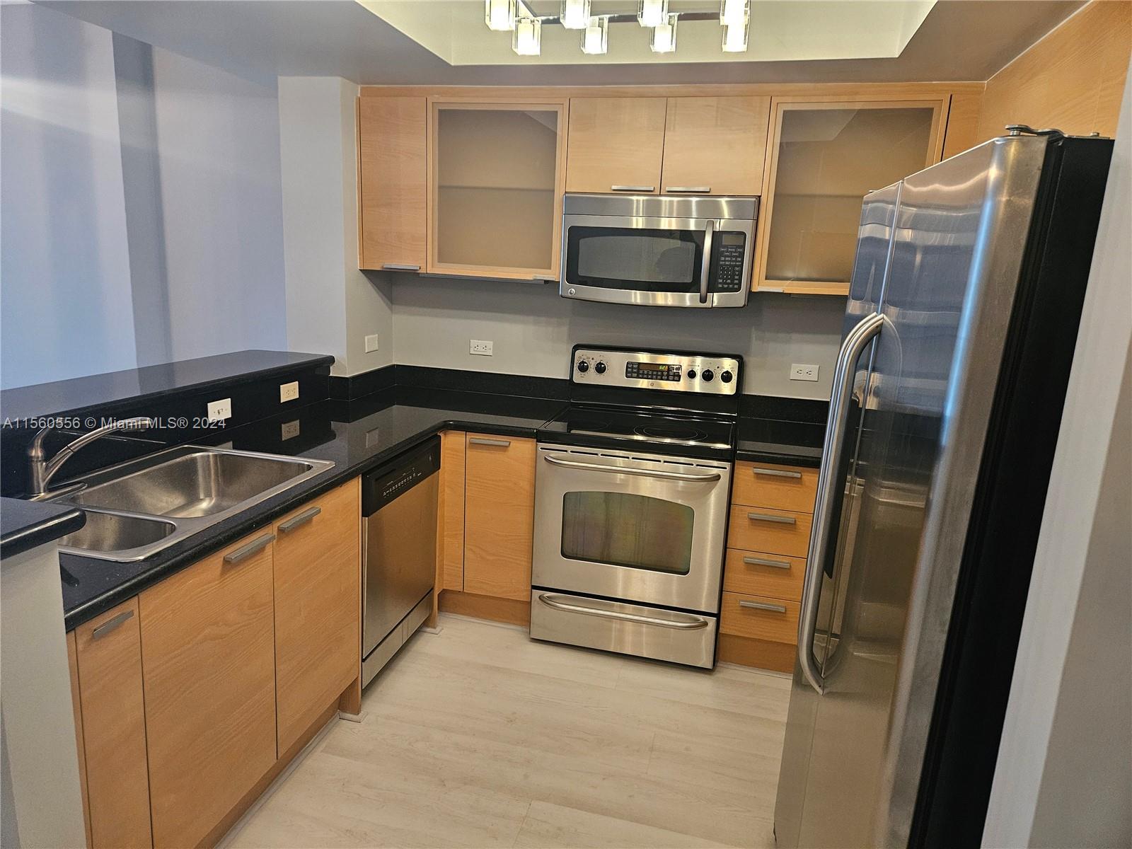 a kitchen with stainless steel appliances a sink stove and refrigerator