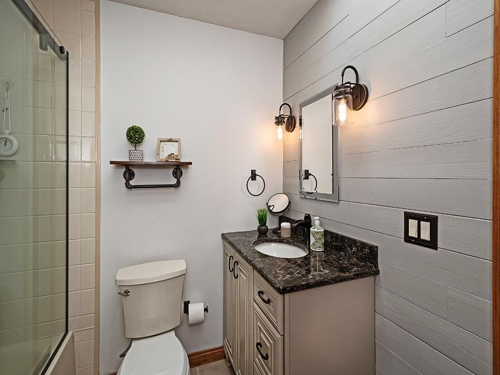 638 Knoll Lane Apollo, PA 15613 - Photo 20 of 30 a bathroom with a granite countertop toilet sink and mirror
