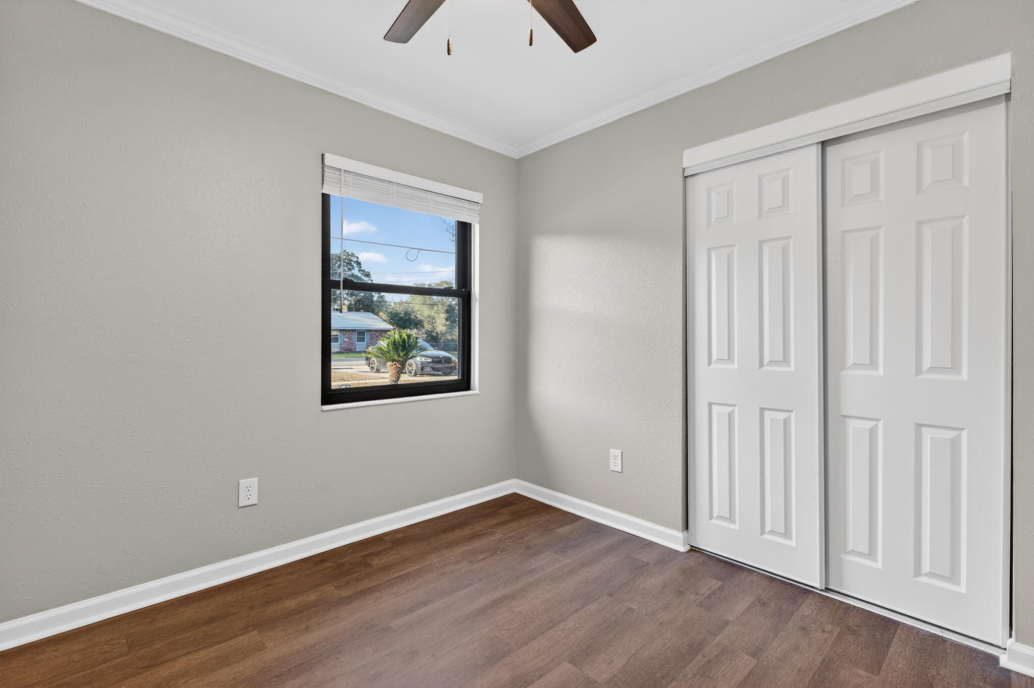 420 Paradise Road Niceville, FL 32578 - Photo 14 of 38 an empty room with wooden floor closet and windows