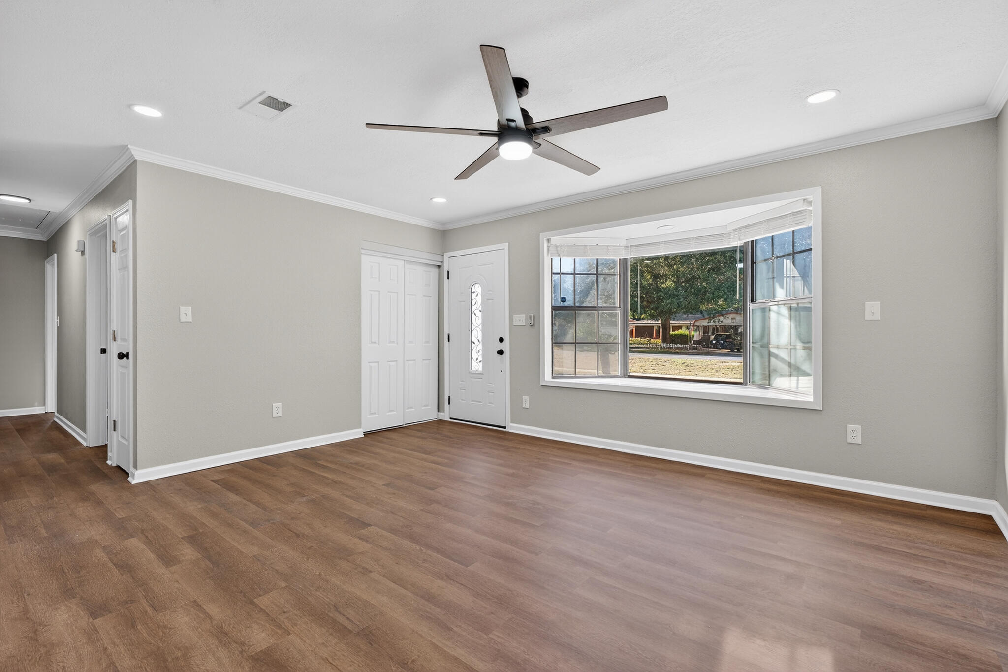 420 Paradise Road Niceville, FL 32578 - Photo 15 of 38 a view of an empty room with wooden floor and a window