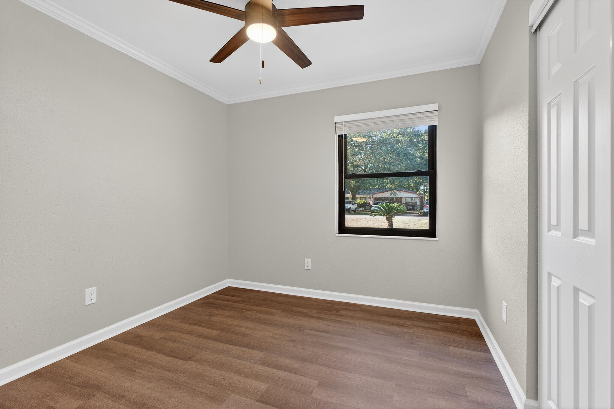 420 Paradise Road Niceville, FL 32578 - Photo 16 of 38 a view of an empty room with wooden floor and window