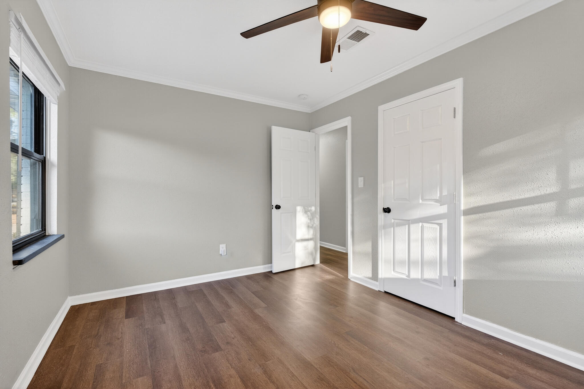 420 Paradise Road Niceville, FL 32578 - Photo 18 of 38 a view of an empty room with wooden floor and a window