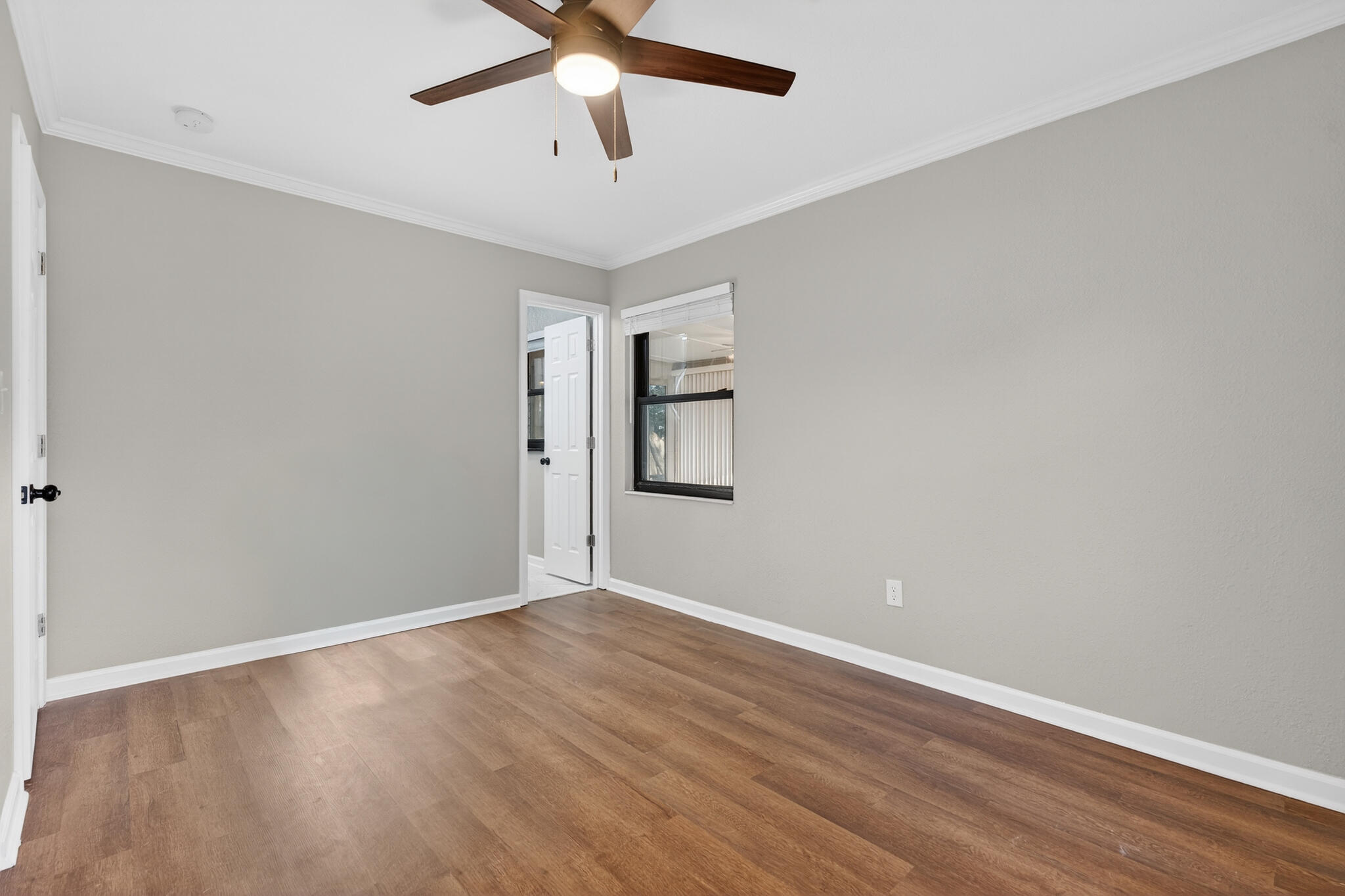 420 Paradise Road Niceville, FL 32578 - Photo 22 of 38 an empty room with wooden floor and windows