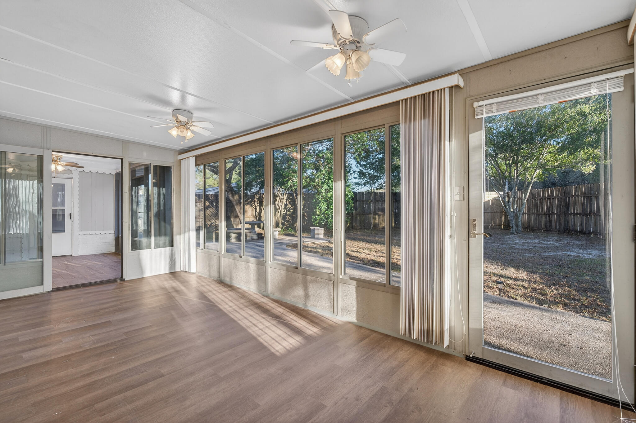 420 Paradise Road Niceville, FL 32578 - Photo 23 of 38 a view of empty room with wooden floor and fan