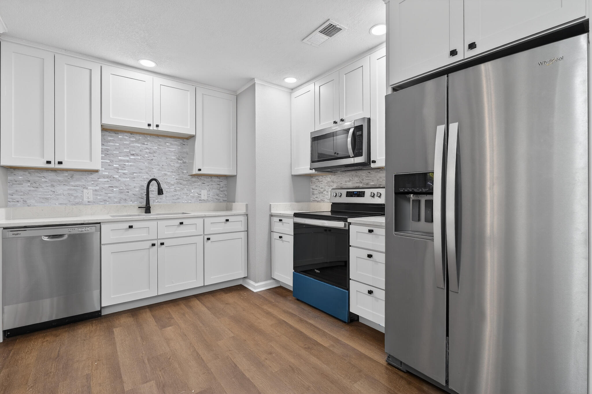 420 Paradise Road Niceville, FL 32578 - Photo 4 of 38 a kitchen with stainless steel appliances white cabinets and a sink