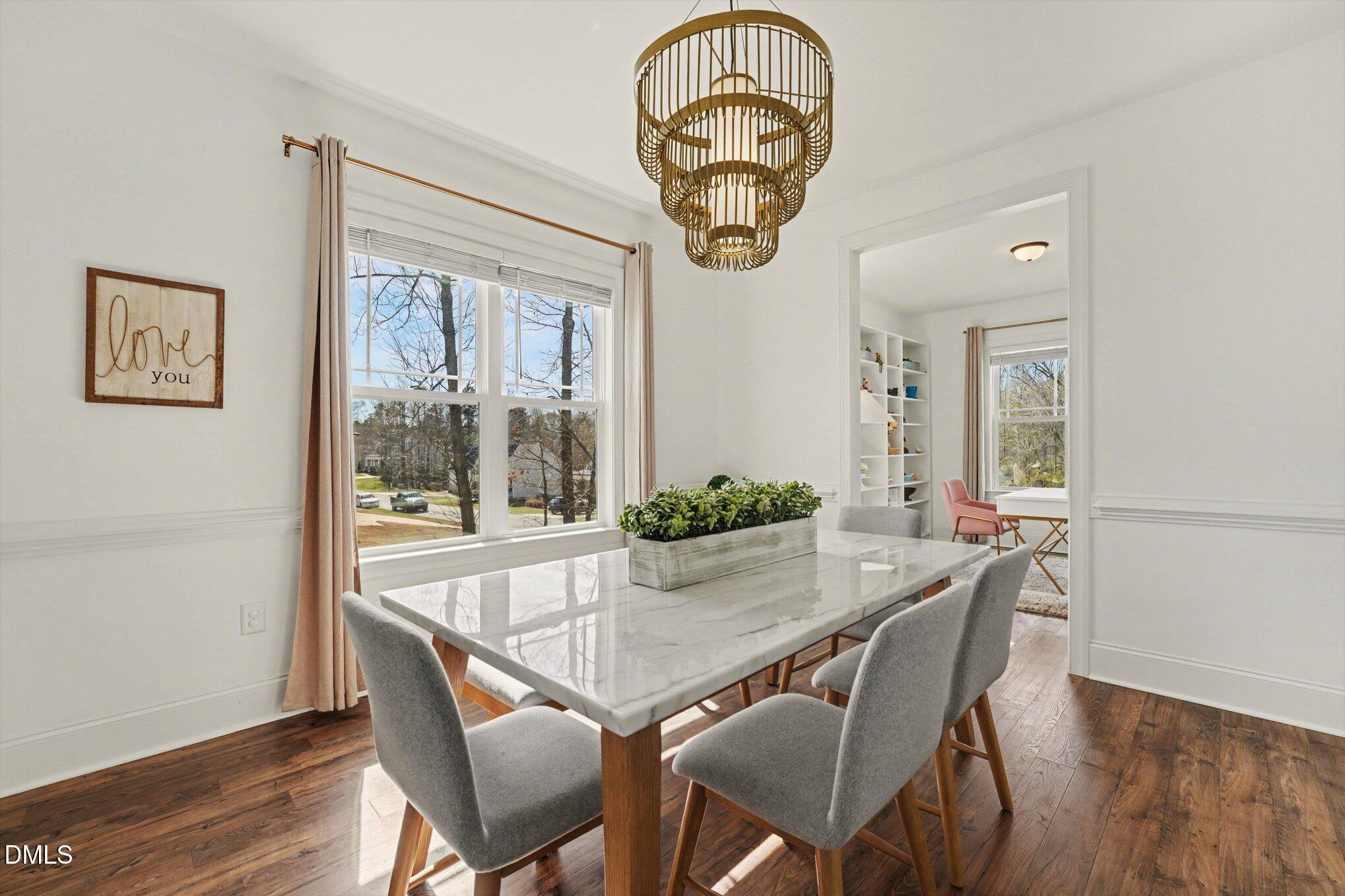209 Timber Wolf Crossing Garner, NC 27529 - Photo 11 of 38 a view of a dining room with furniture window and wooden floor