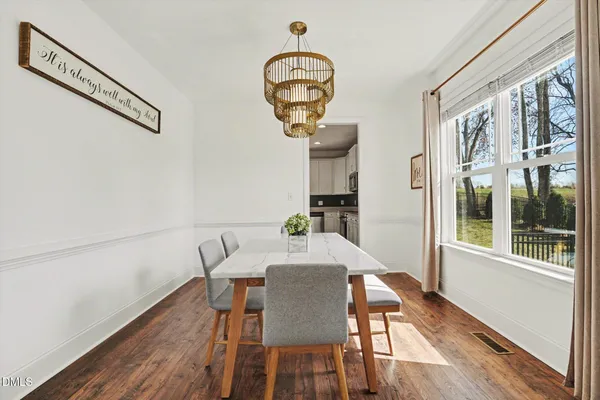 a view of a dining room with furniture window and wooden floor