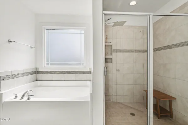 a bathroom with a tub sink and a mirror