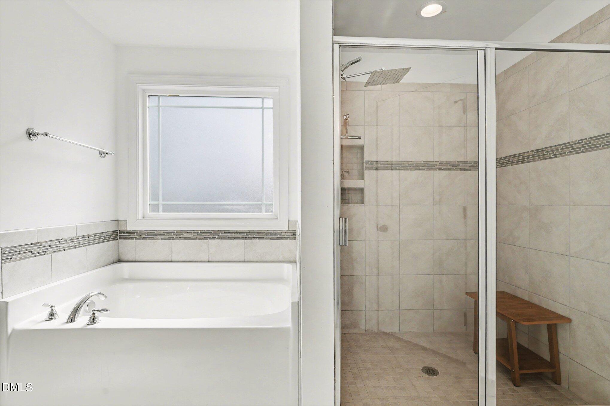 209 Timber Wolf Crossing Garner, NC 27529 - Photo 20 of 38 a bathroom with a bathtub and shower