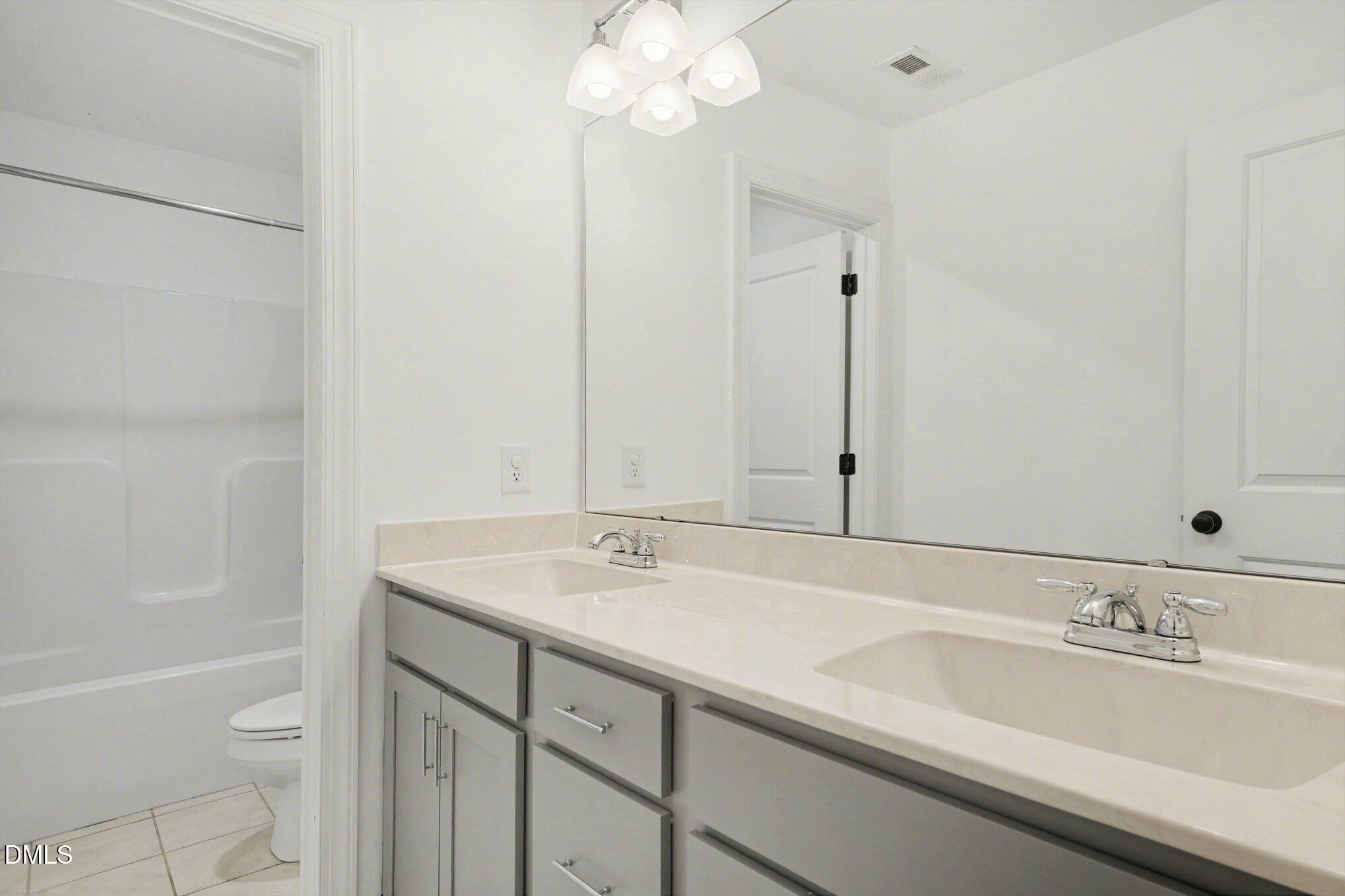 209 Timber Wolf Crossing Garner, NC 27529 - Photo 21 of 38 a bathroom with a sink a toilet and a bathtub