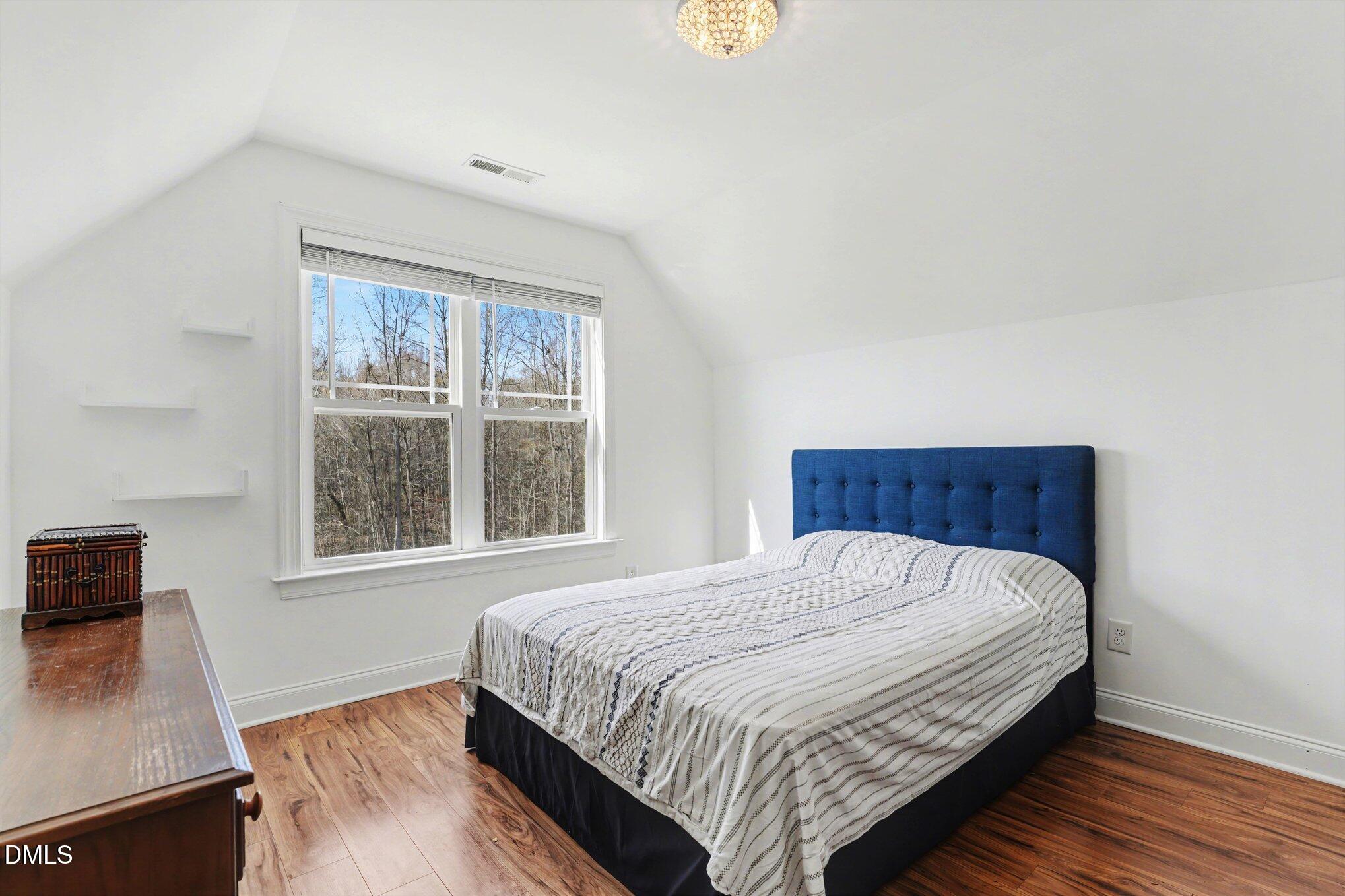 209 Timber Wolf Crossing Garner, NC 27529 - Photo 24 of 38 a bedroom with a bed and a window
