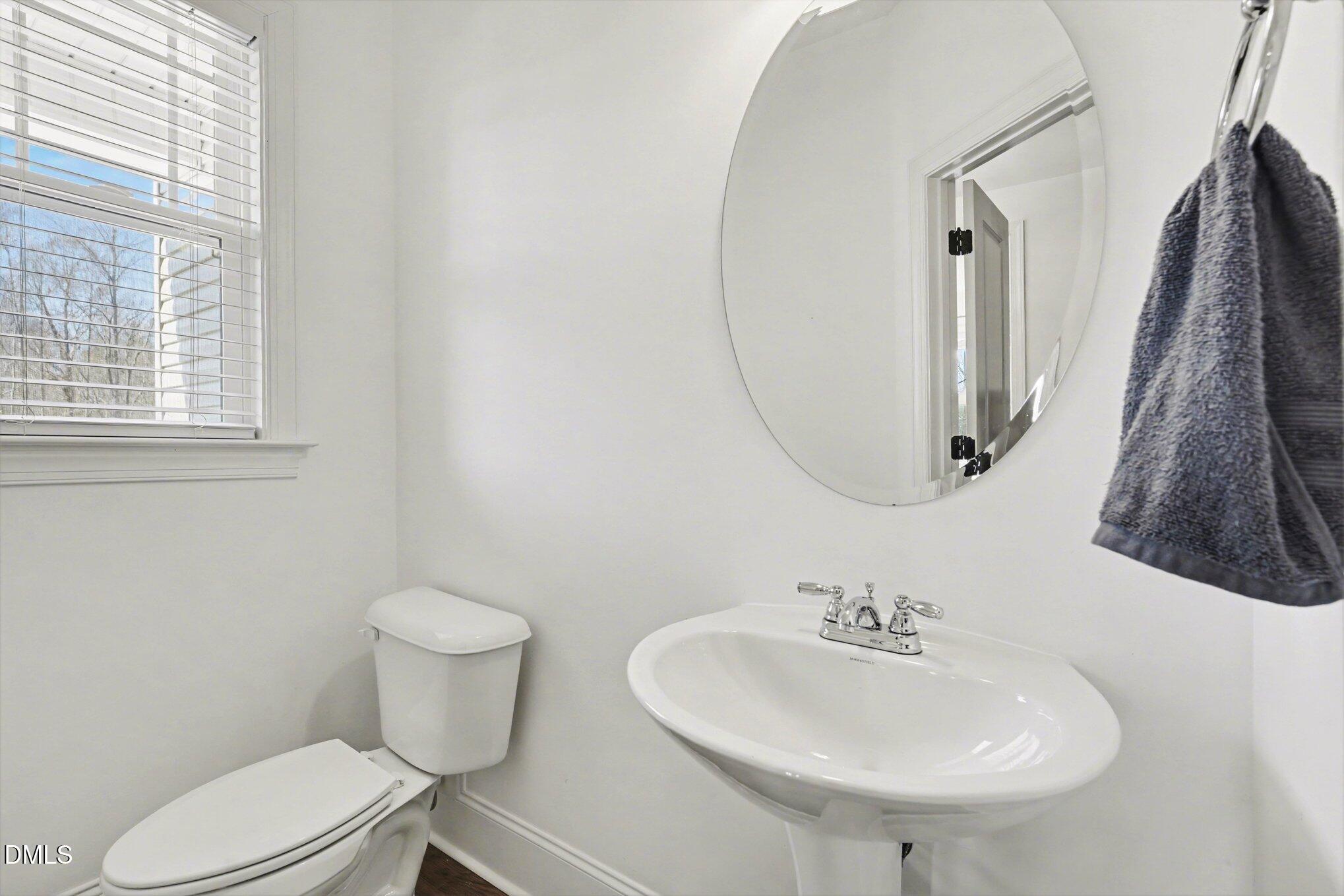 209 Timber Wolf Crossing Garner, NC 27529 - Photo 25 of 38 a bathroom with a toilet sink and mirror