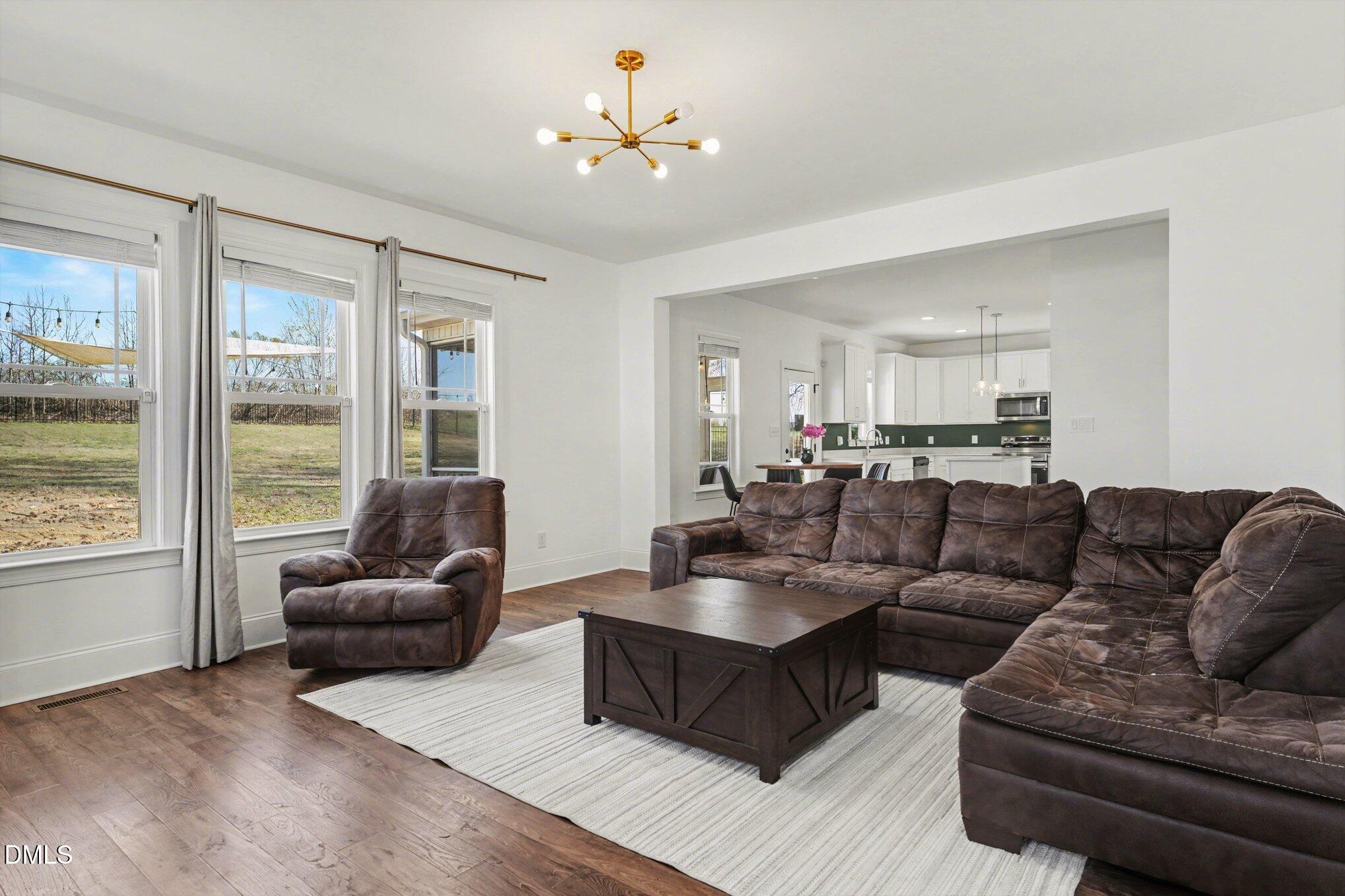 209 Timber Wolf Crossing Garner, NC 27529 - Photo 6 of 38 a living room with furniture and a large window