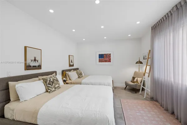 a bedroom with a bed and a painting