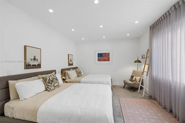 a bedroom with a bed and a painting