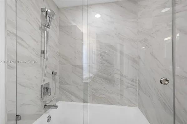 a bedroom with a large bed and a large window