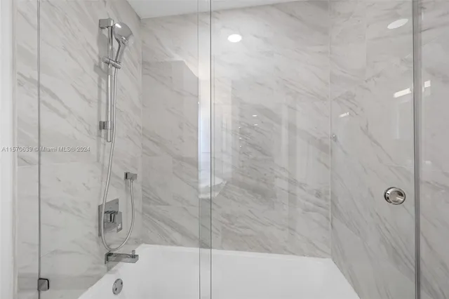 a bedroom with a large bed and a large window