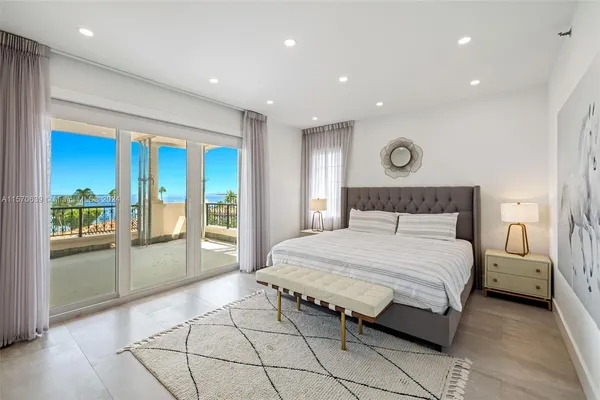 a spacious bedroom with a bed and a cabinets