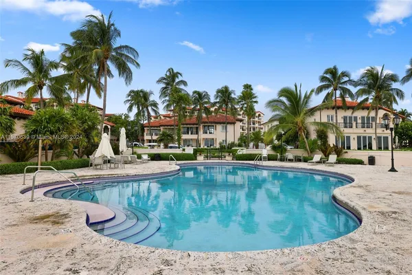 a swimming pool with trees in the background