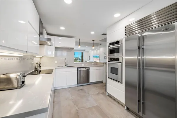 a kitchen with a sink stainless steel appliances and cabinets