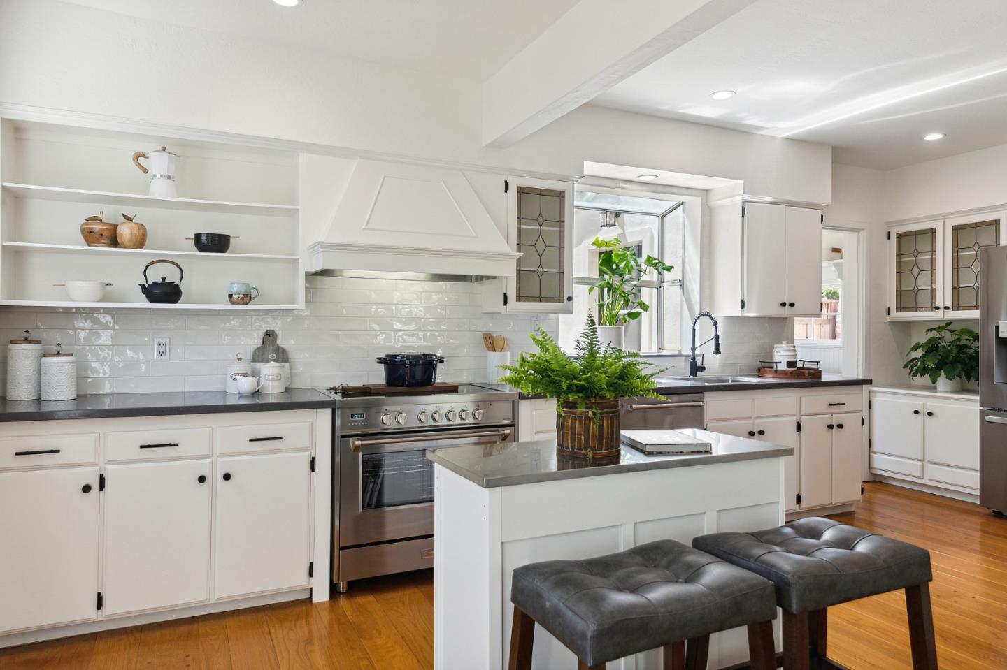 321 Bloomfield Road Burlingame, CA 94010 - Photo 15 of 45 a kitchen with white cabinets and wooden floor