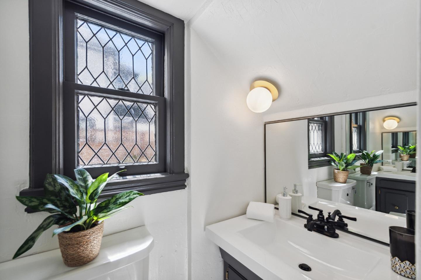 321 Bloomfield Road Burlingame, CA 94010 - Photo 21 of 45 a bathroom with a sink a mirror and a window