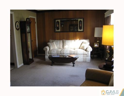 856 Ridge Road Monmouth Junction, NJ 08852 - Photo 3 of 7 a living room with furniture and a fireplace