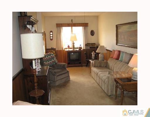 856 Ridge Road Monmouth Junction, NJ 08852 - Photo 5 of 7 a living room with furniture and a window