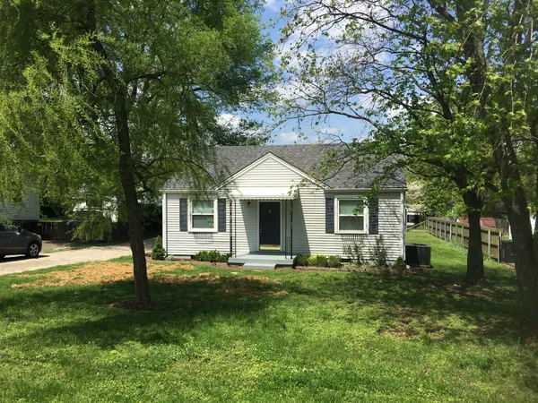 a backyard of a house with yard and tree