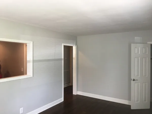 an empty room with wooden floor
