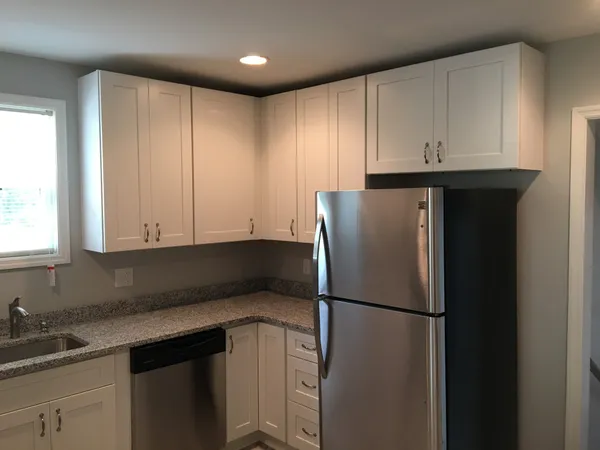 a kitchen with a refrigerator and a sink