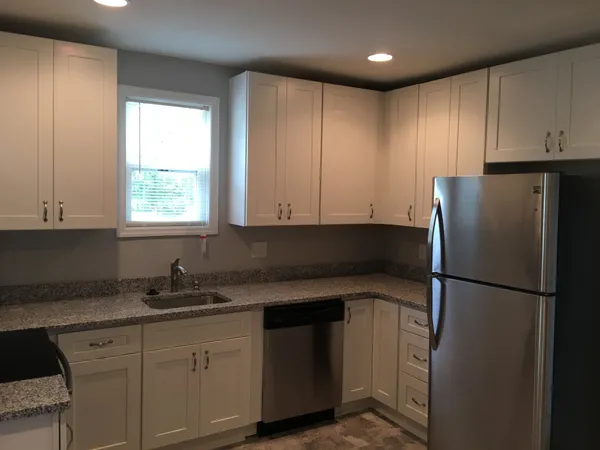 a kitchen with a refrigerator and a sink