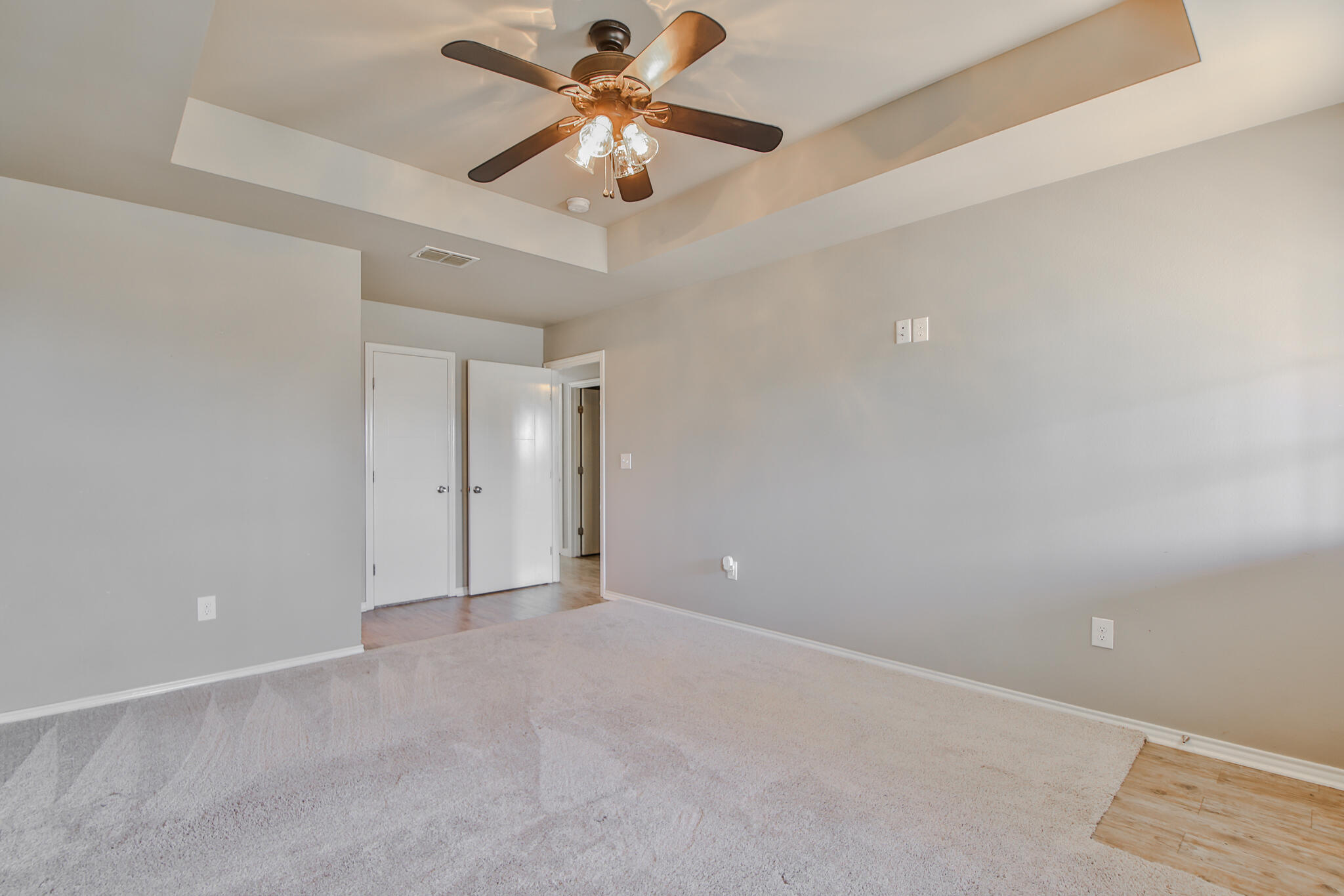 6205 21st Street Lubbock, TX 79407 - Photo 12 of 22 an empty room with a ceiling fan and a fan