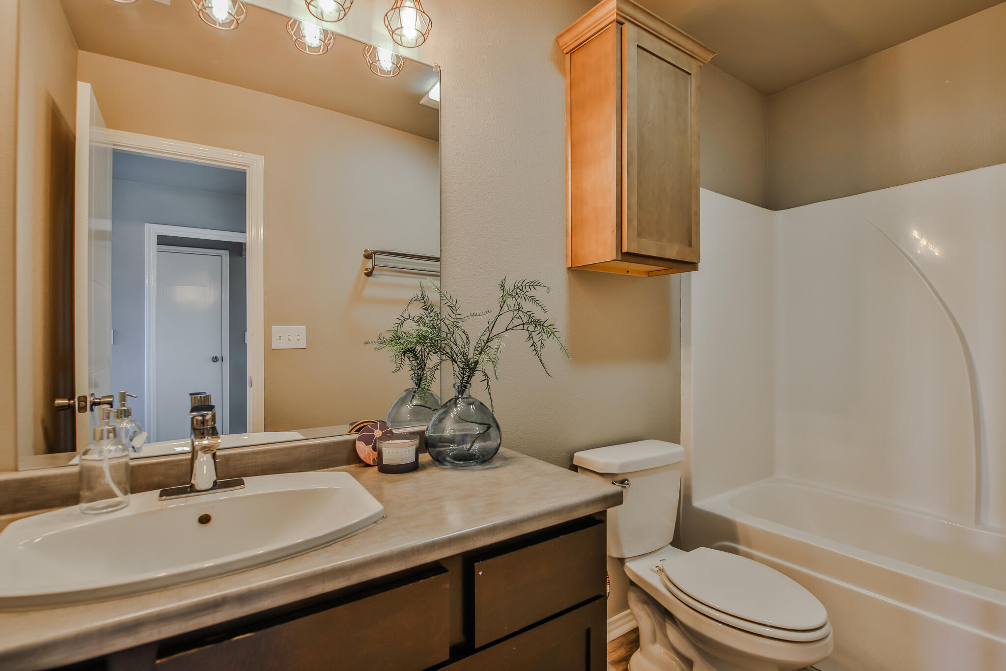 6205 21st Street Lubbock, TX 79407 - Photo 13 of 22 a bathroom with a sink a toilet and shower