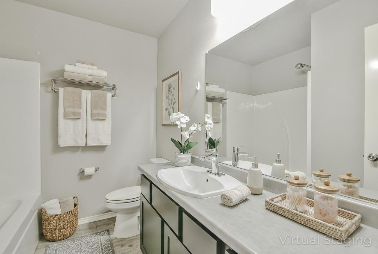 6205 21st Street Lubbock, TX 79407 - Photo 15 of 22 a bathroom with a granite countertop sink and a mirror