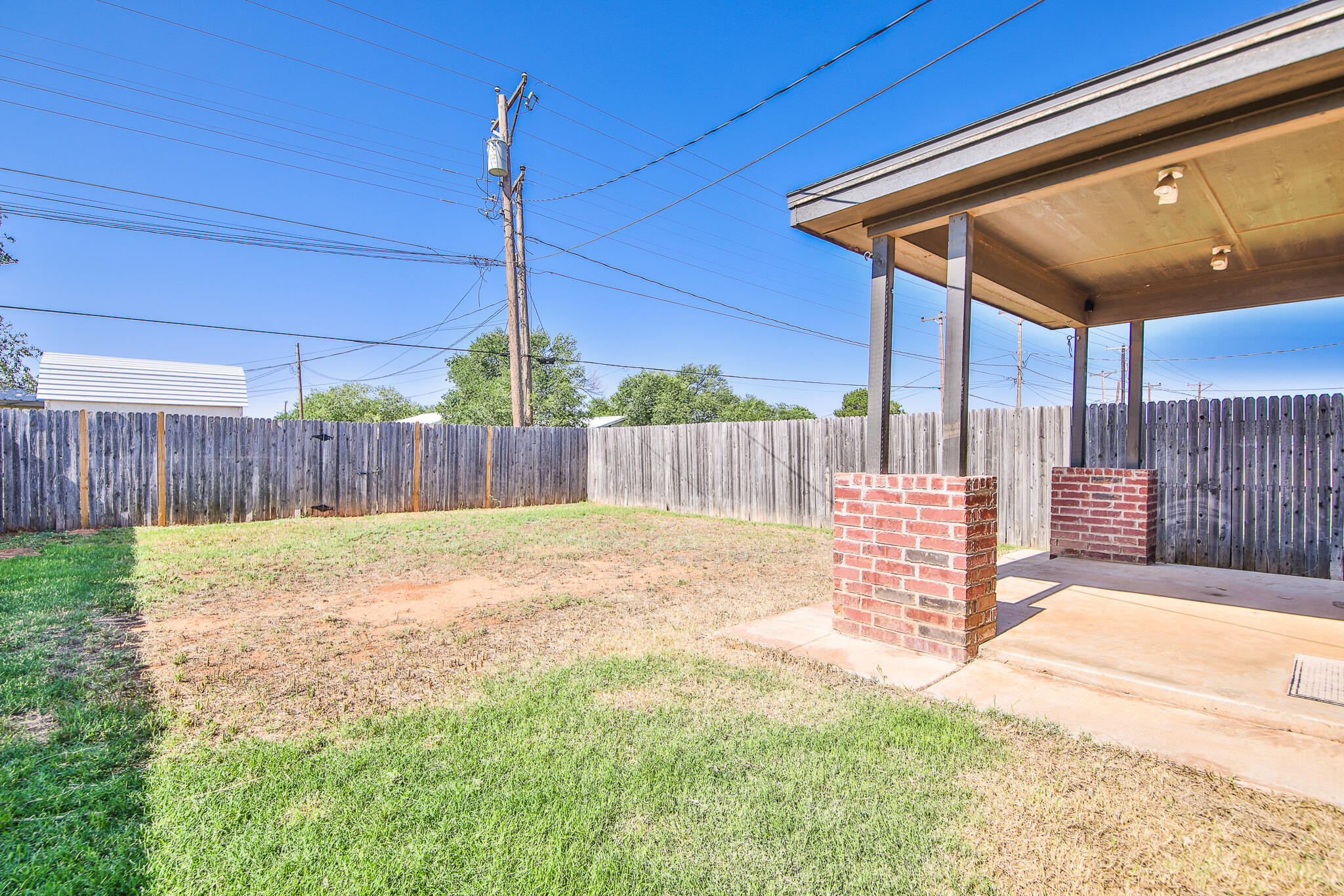 6205 21st Street Lubbock, TX 79407 - Photo 18 of 22 a view of a backyard with a swing