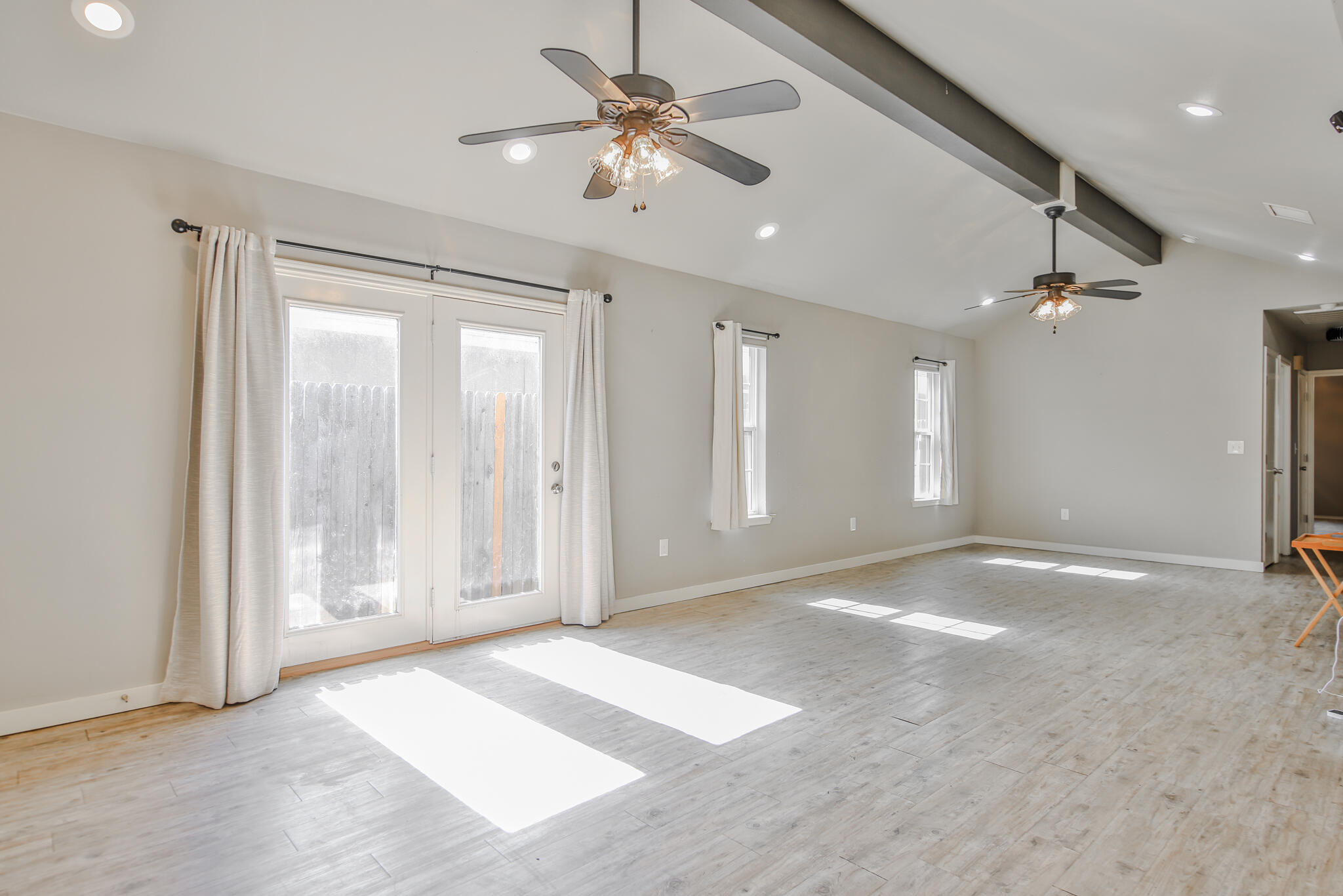 6205 21st Street Lubbock, TX 79407 - Photo 3 of 22 a view of an empty room with a ceiling fan