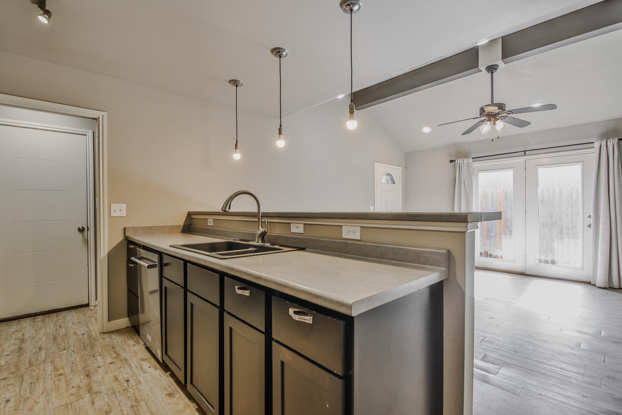 6205 21st Street Lubbock, TX 79407 - Photo 6 of 22 a kitchen with a sink a counter space and wooden floor