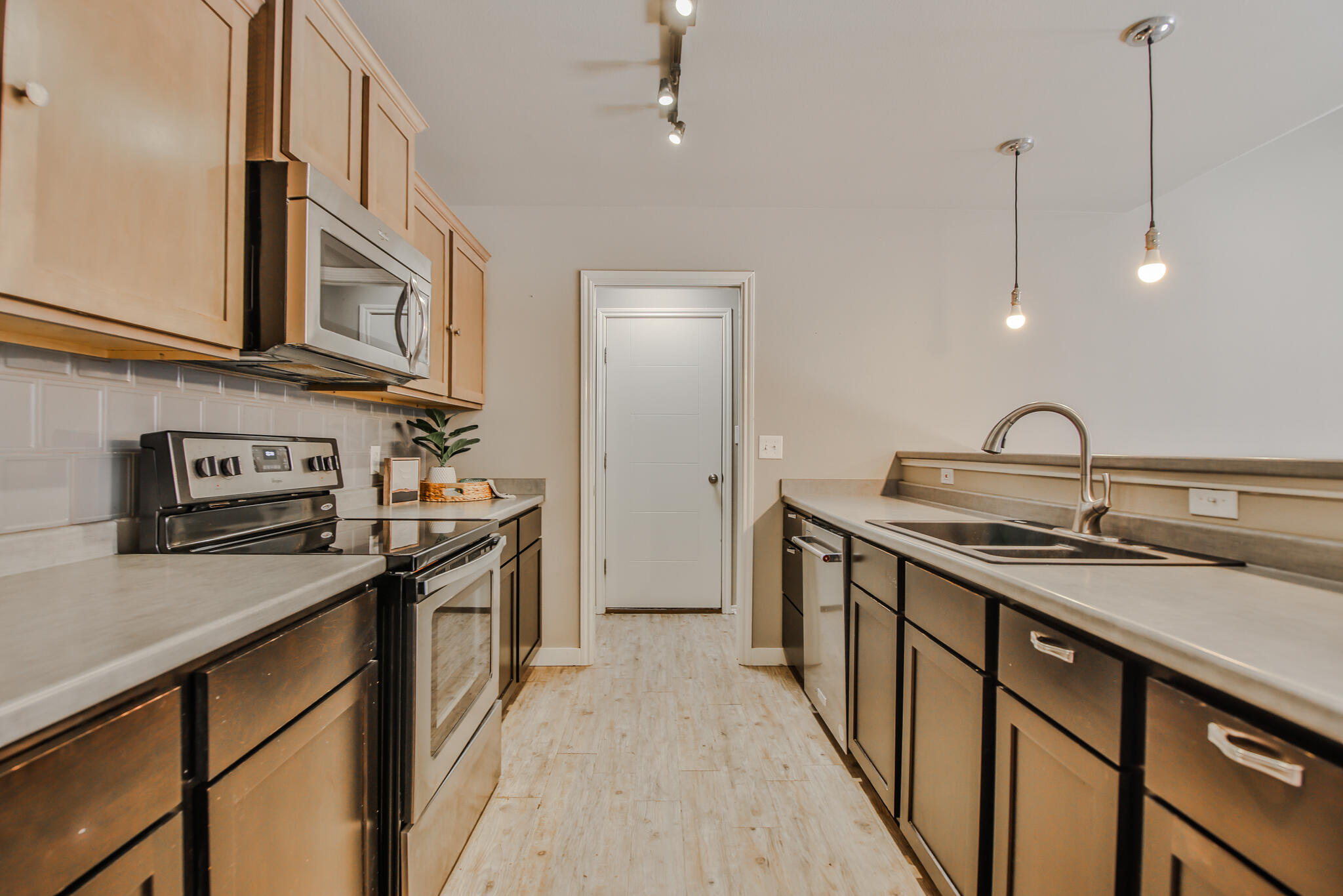 6205 21st Street Lubbock, TX 79407 - Photo 7 of 22 a kitchen with stainless steel appliances granite countertop a sink a stove and a refrigerator