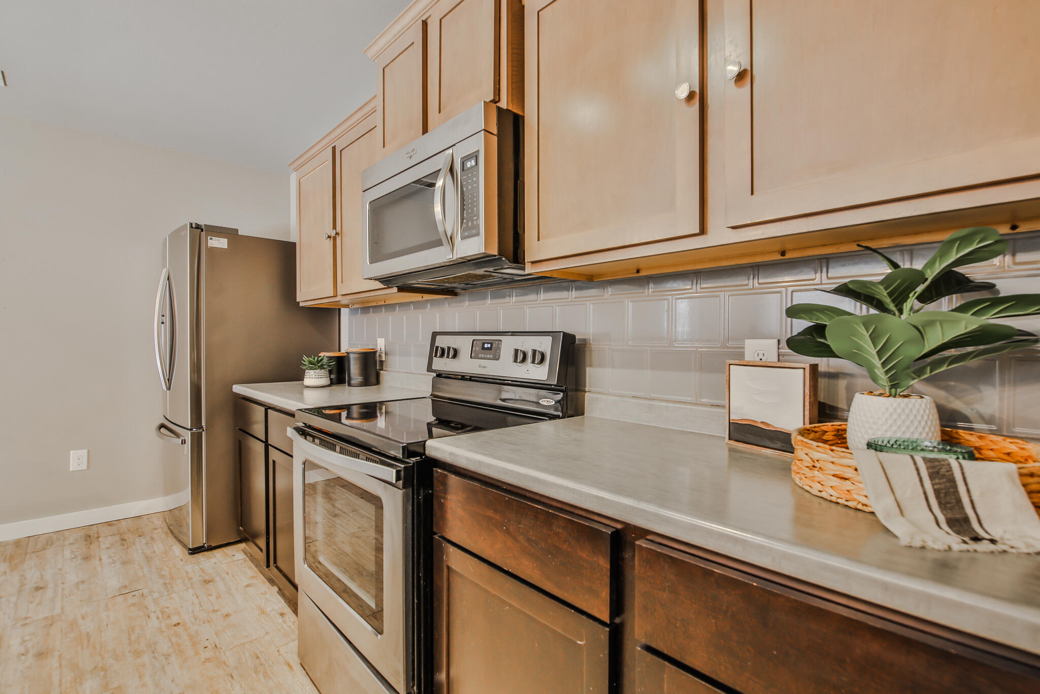 6205 21st Street Lubbock, TX 79407 - Photo 8 of 22 a kitchen with stainless steel appliances granite countertop a refrigerator a stove a sink and white cabinets