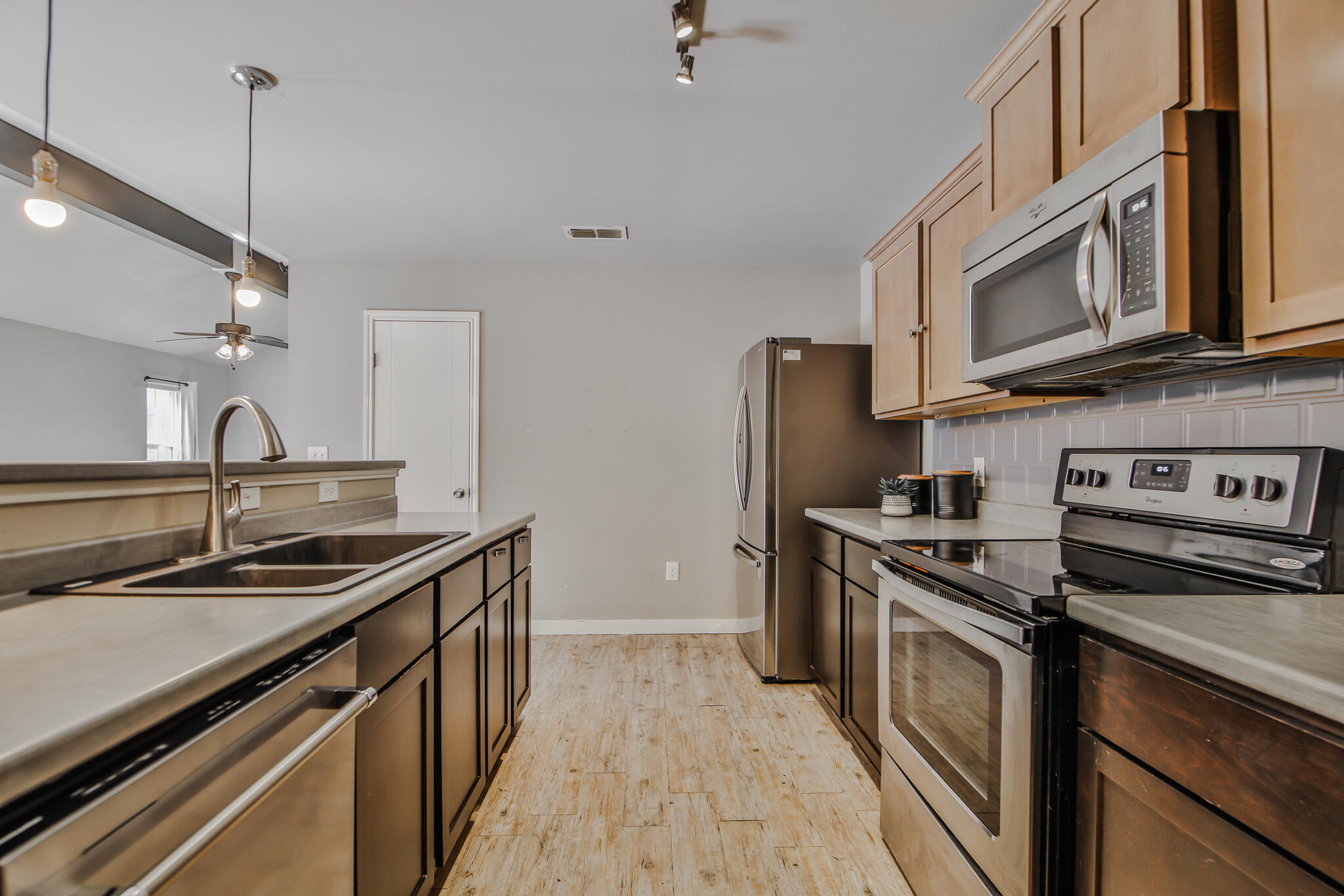 6205 21st Street Lubbock, TX 79407 - Photo 9 of 22 a kitchen with stainless steel appliances granite countertop a sink stove and refrigerator