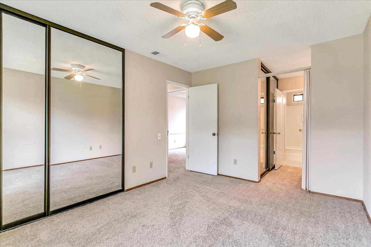 94 Saddlebrook Drive San Jose, CA 95136 - Photo 16 of 32 an empty room with windows and a ceiling fan