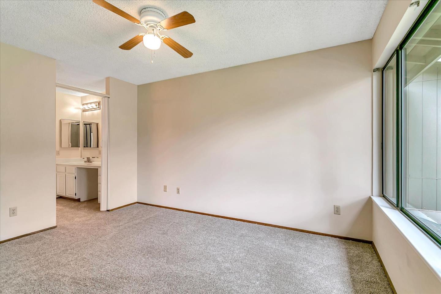 94 Saddlebrook Drive San Jose, CA 95136 - Photo 17 of 32 a view of a room with a ceiling fan and window