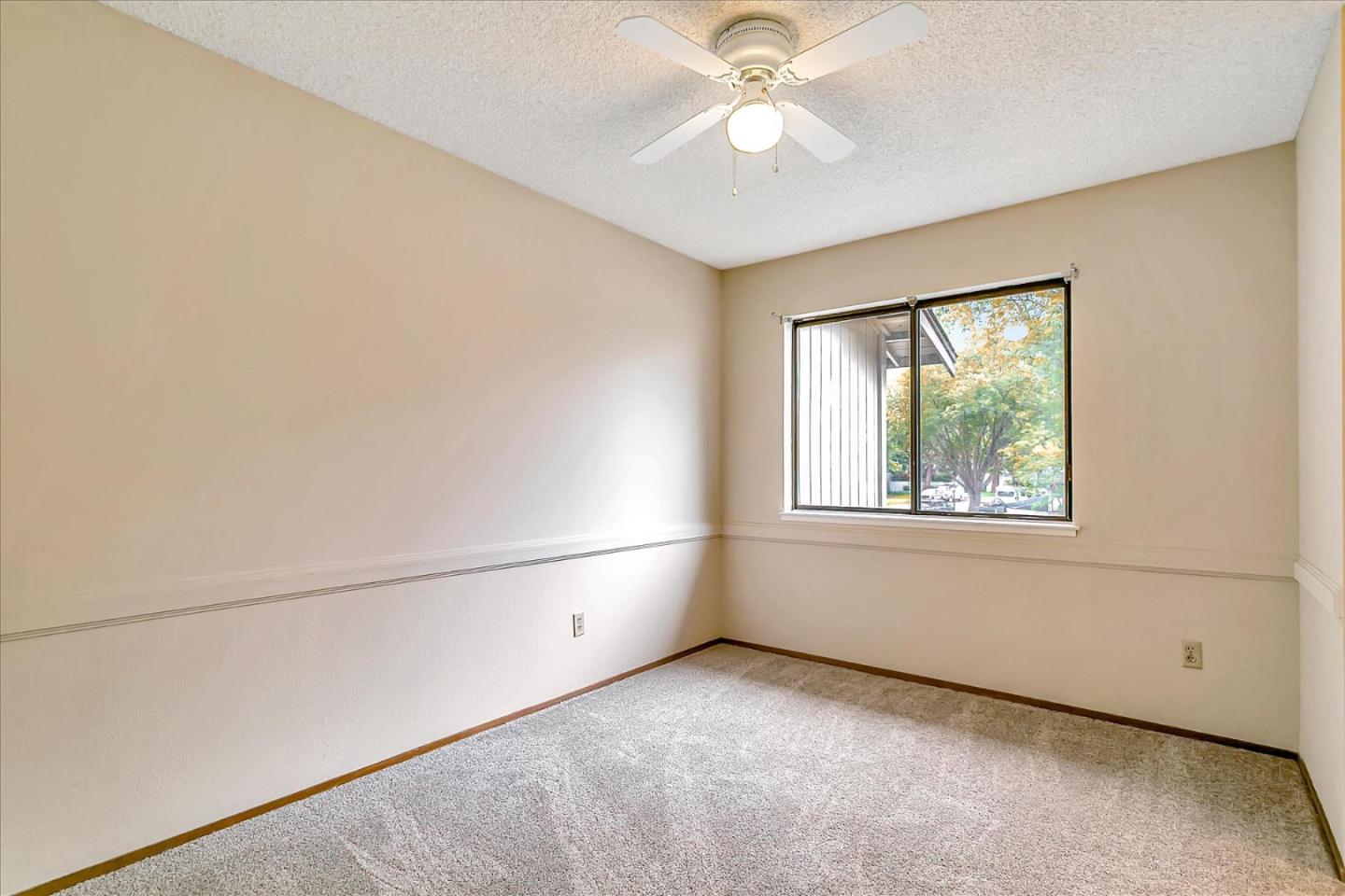 94 Saddlebrook Drive San Jose, CA 95136 - Photo 18 of 32 an empty room with windows and fan