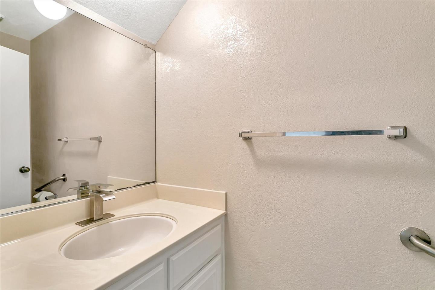 94 Saddlebrook Drive San Jose, CA 95136 - Photo 21 of 32 a bathroom with a sink and a mirror