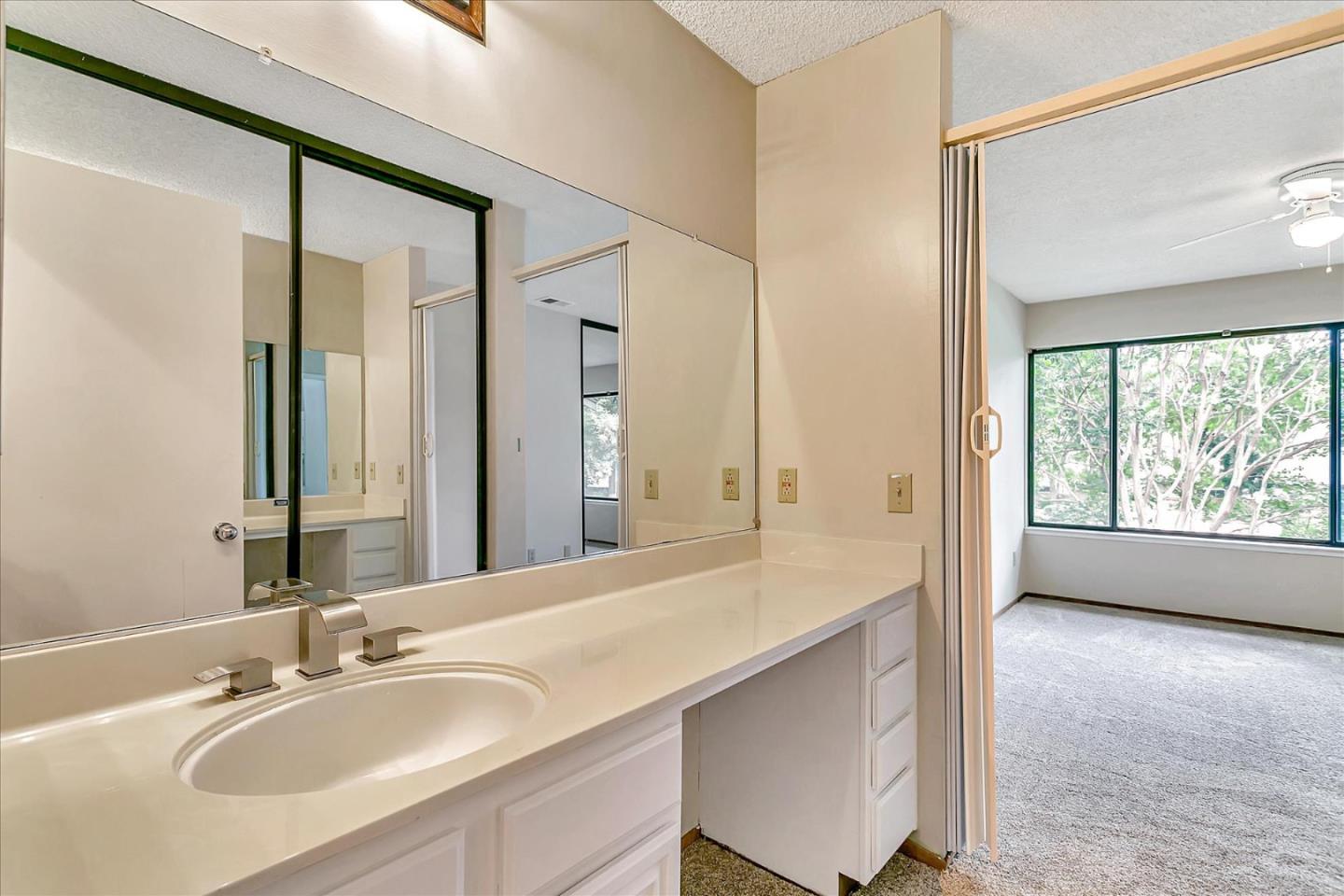 94 Saddlebrook Drive San Jose, CA 95136 - Photo 24 of 32 a bathroom with a double vanity sink and a mirror