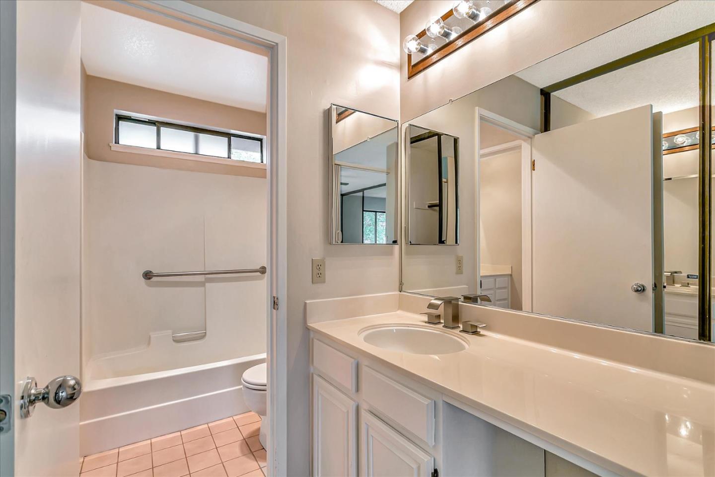 94 Saddlebrook Drive San Jose, CA 95136 - Photo 25 of 32 a bathroom with a granite countertop sink a mirror and a bathtub