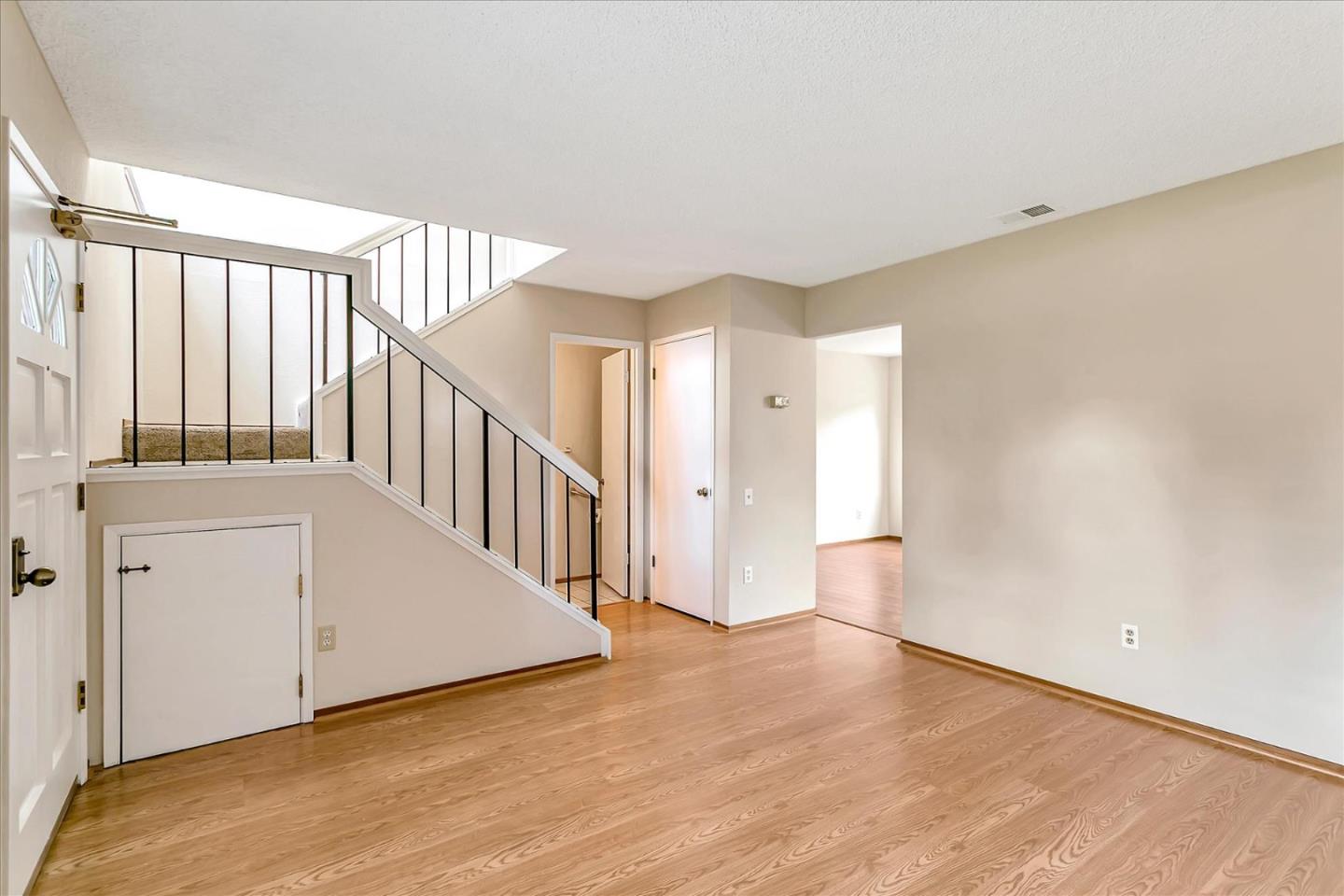 94 Saddlebrook Drive San Jose, CA 95136 - Photo 6 of 32 a view of a hallway with wooden floor and staircase